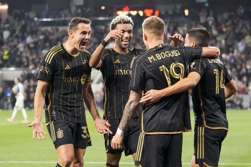 Los Angeles FC midfielder Mateusz Bogusz (19) celebrates his goal against Minnesota United with, from left, defender Aaron Long, midfielder Timothy Tillman and defender Sergi Palencia during the second half of an MLS soccer match Wednesday, May 29, 2024, in Los Angeles. (AP Photo/Ryan Sun)