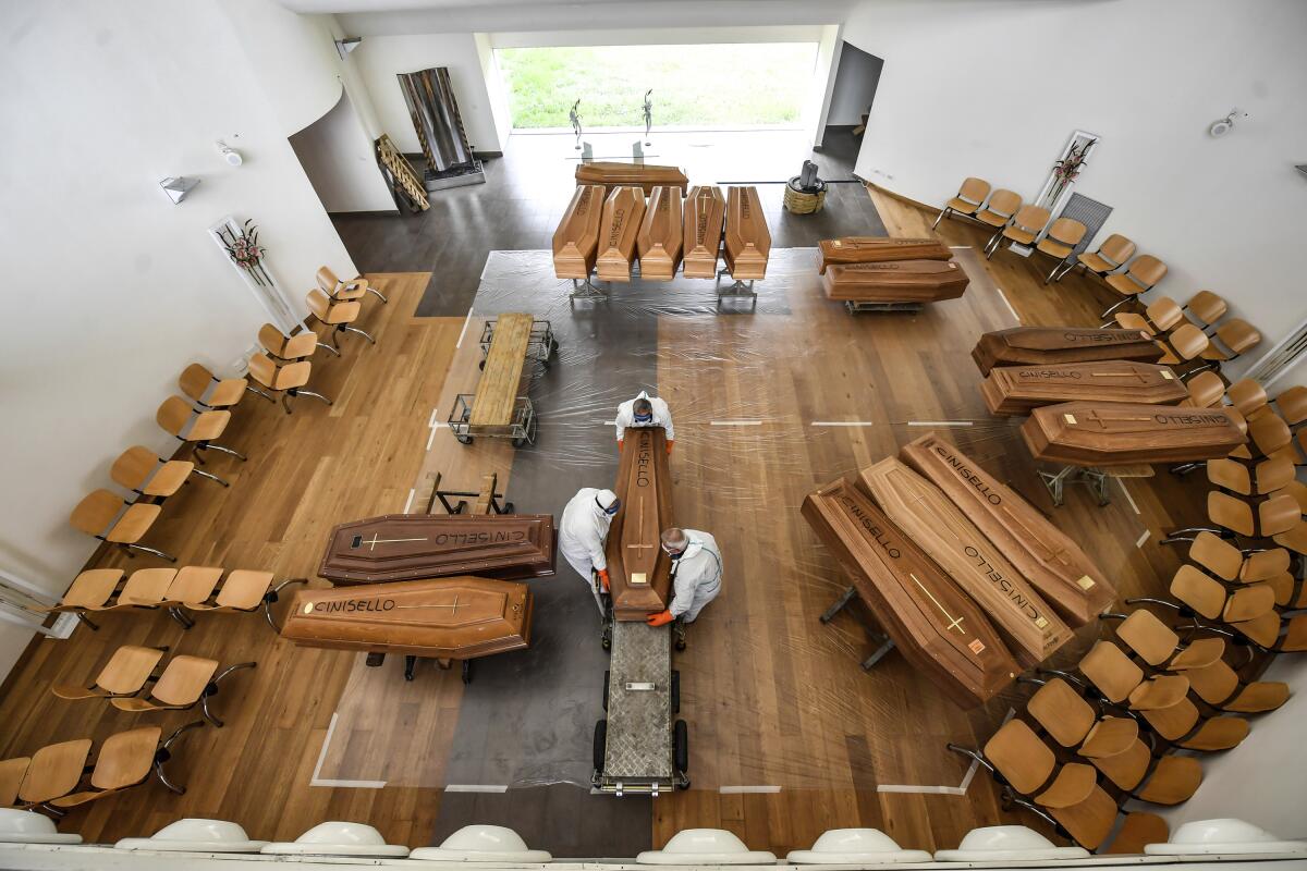 Coffins are unloaded at a cemetery near Milan.