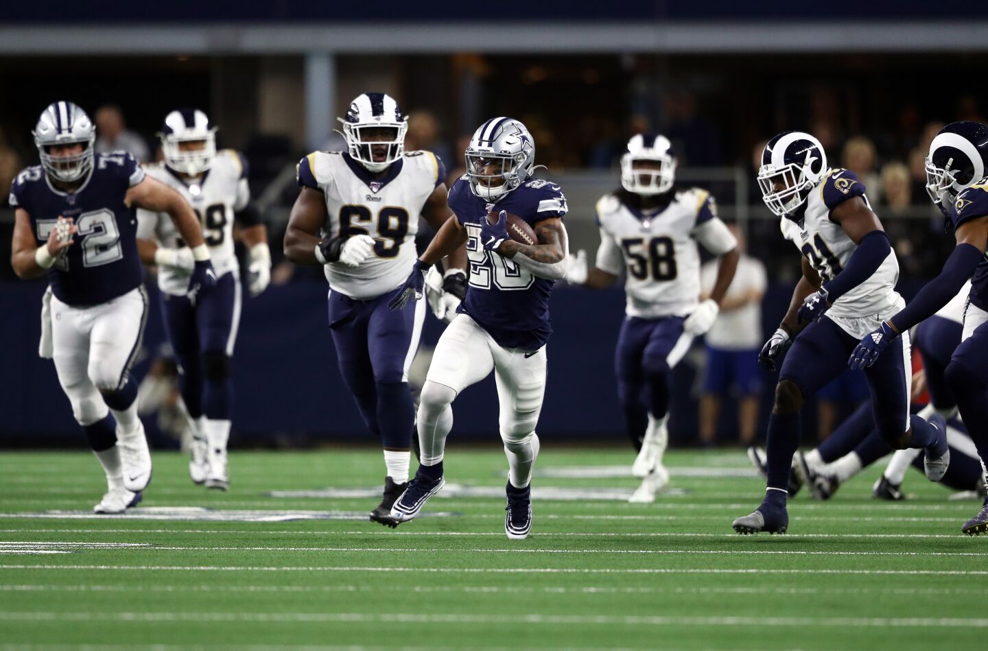 Dallas Cowboys running back Tony Pollard sprints away from the Rams' defense during the second half.