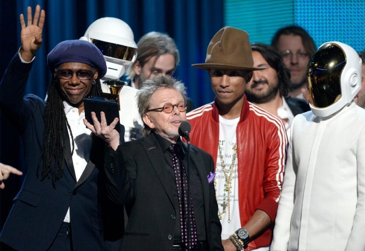 Pharrell Willams, seen here with the Grammy Award-winning team for Daft Punk's "Random Access Memories," has put his hat up for auction.