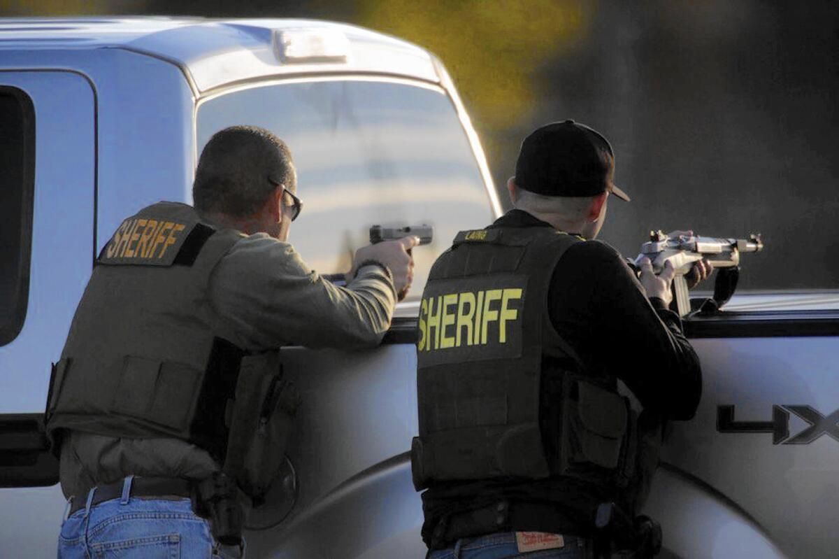 Deputies take aim on the perimeter of the shootout in San Bernardino.