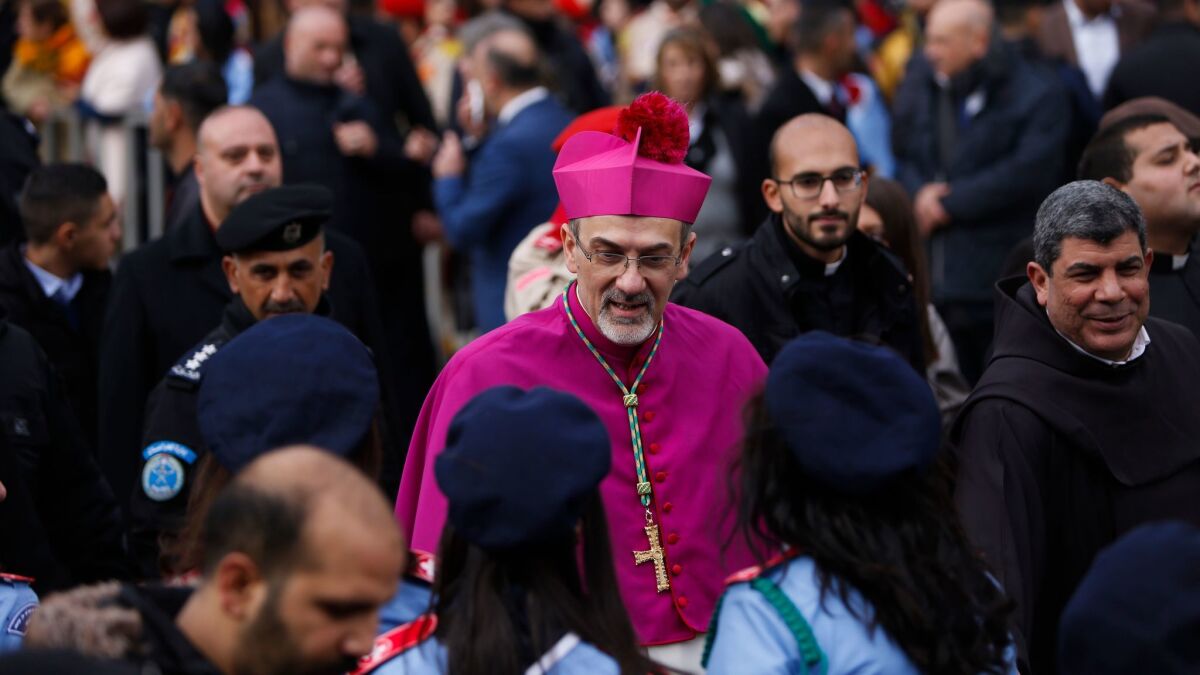 The Latin patriarch of Jerusalem, Pierbattista Pizzaballa, arrives to the Church of the Nativity, built atop the site where Christians believe Jesus was born, on Christmas Eve in the West Bank city of Bethlehem.