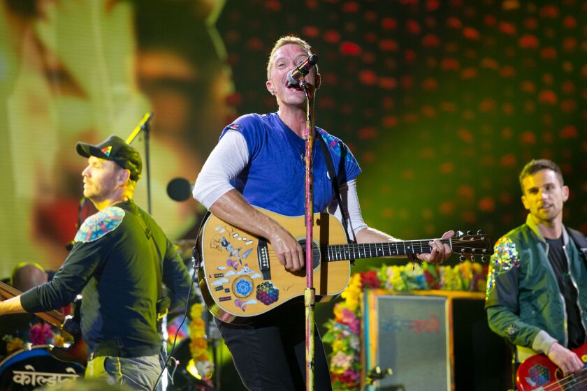 PASADENA, CA - AUGUST 20, 2016: Coldplay performs at the Rose Bowl. From left are, lead guitarist Jonny Buckland, lead singer Chris Martin and bassist Guy Berryman. (Michael Owen Baker / For The Times)