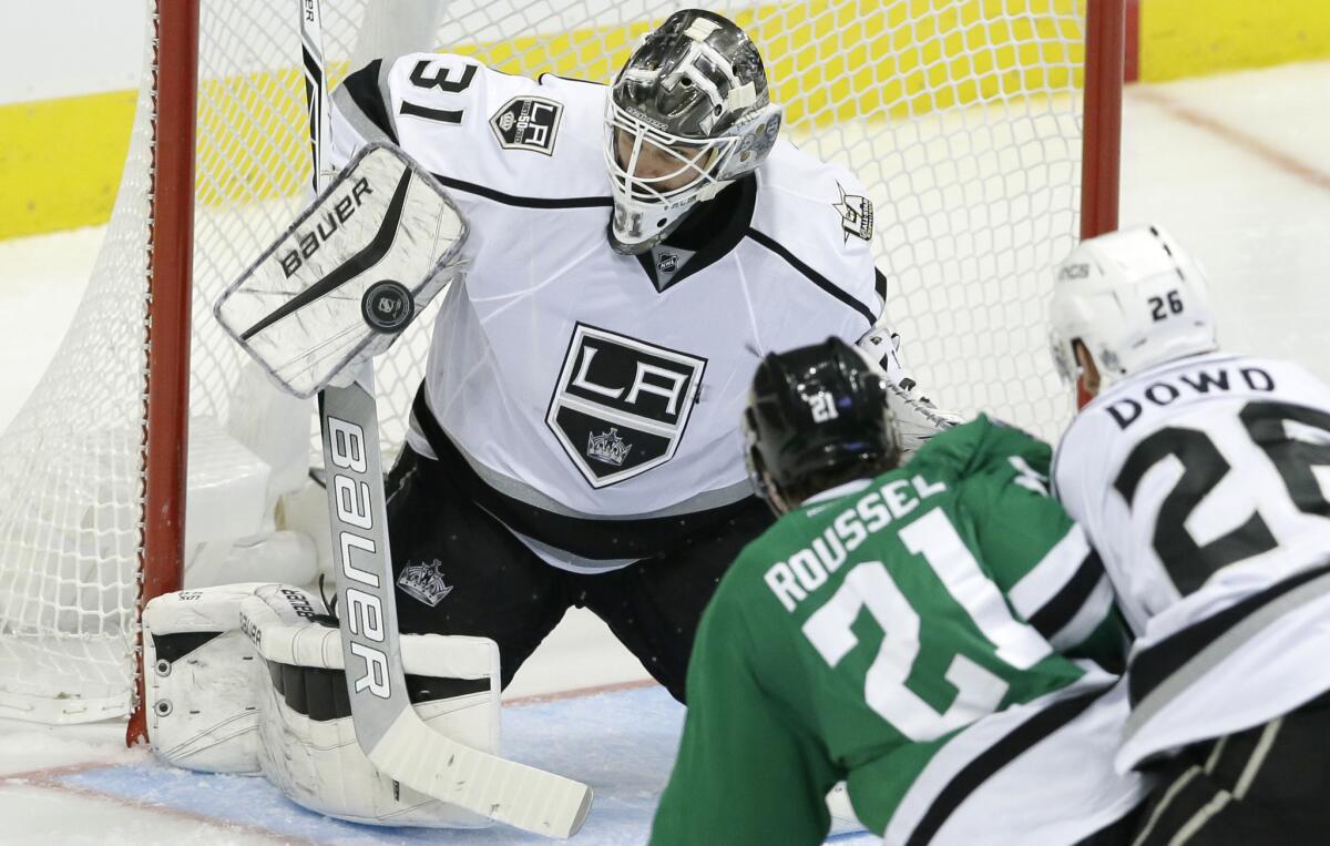 Kings goalie Peter Budaj (31) blocks a shot in front of Stars left wing Antoine Roussel (21) and Kings center Nic Dowd (26) during the third period.