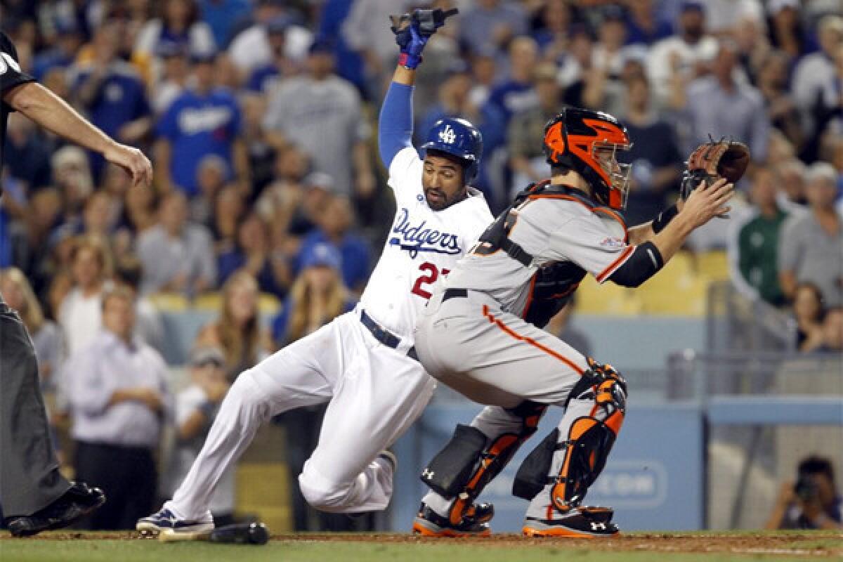 Matt Kemp scores on a Mark Ellis single during the Dodgers' 6-5 victory over the San Francisco Giants in the center fielder's return to the lineup from the disabled list.