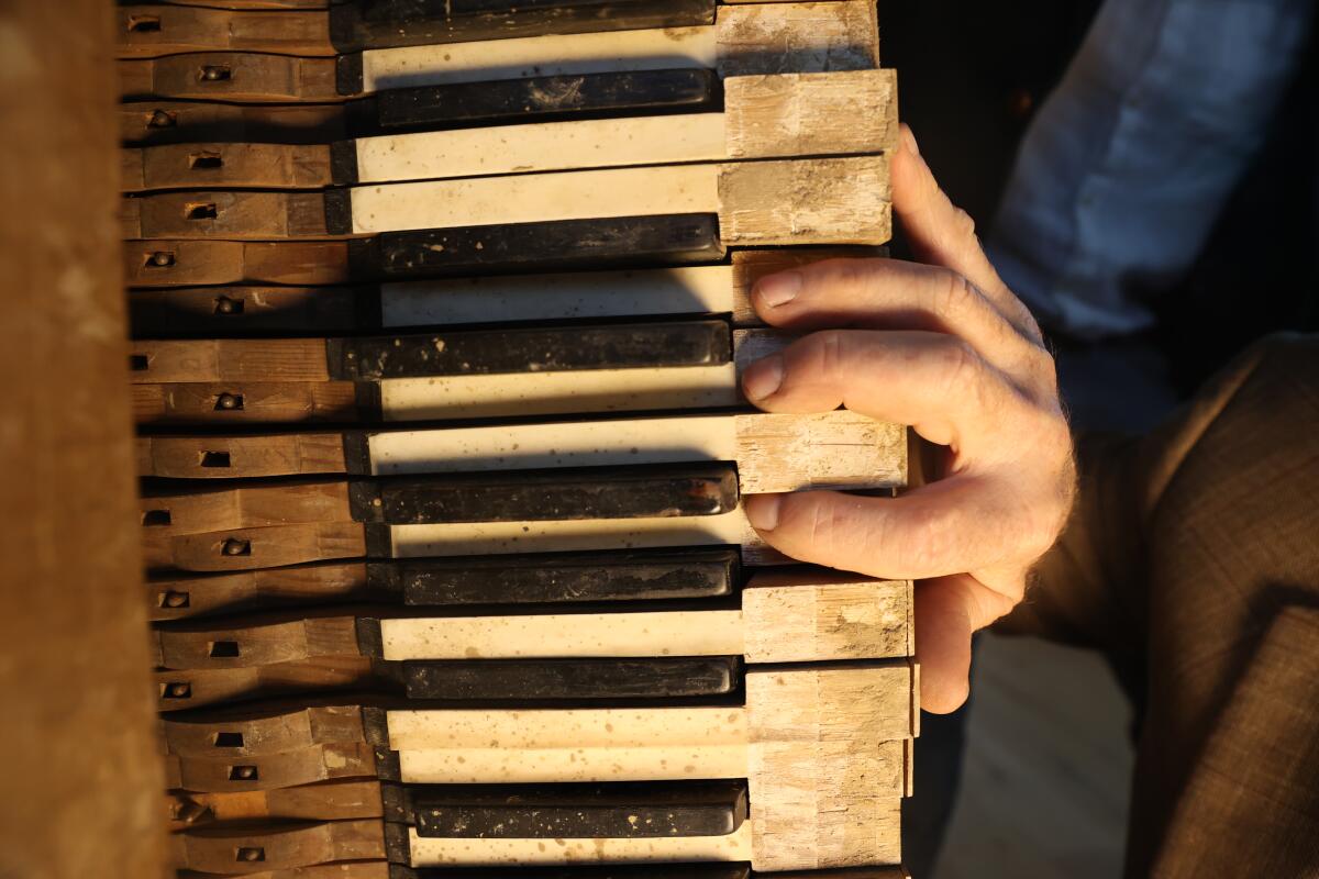 Kyril Kasimoff plays a 149-year-old piano at a gallery in Malibu.