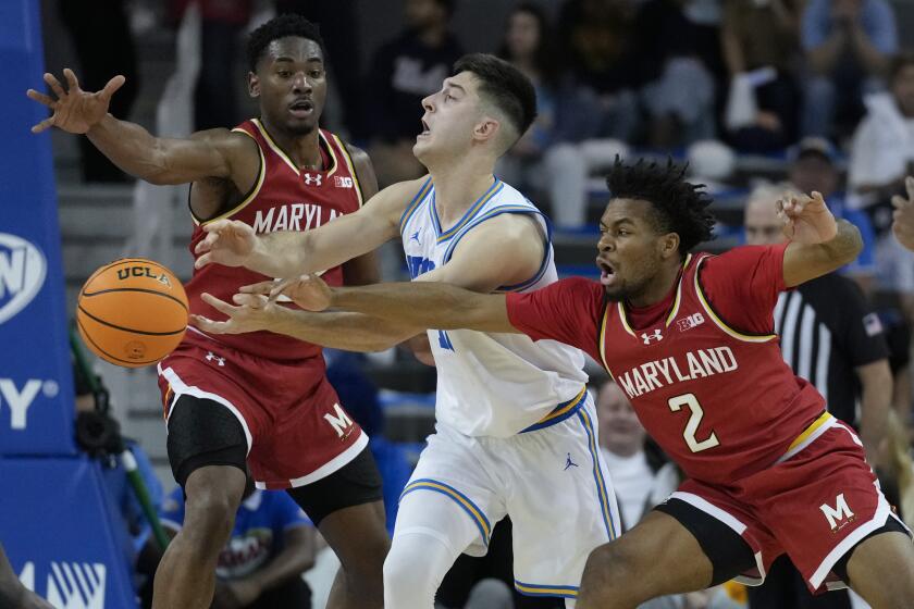 Maryland guard Jahari Long (2) knocks the ball from the hands of UCLA guard Lazar Stefanovic.