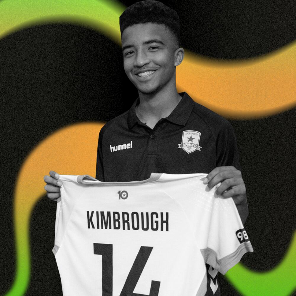 Da'vian Kimbrough, 13, holds up his jersey after signing contract with the Sacramento Republic