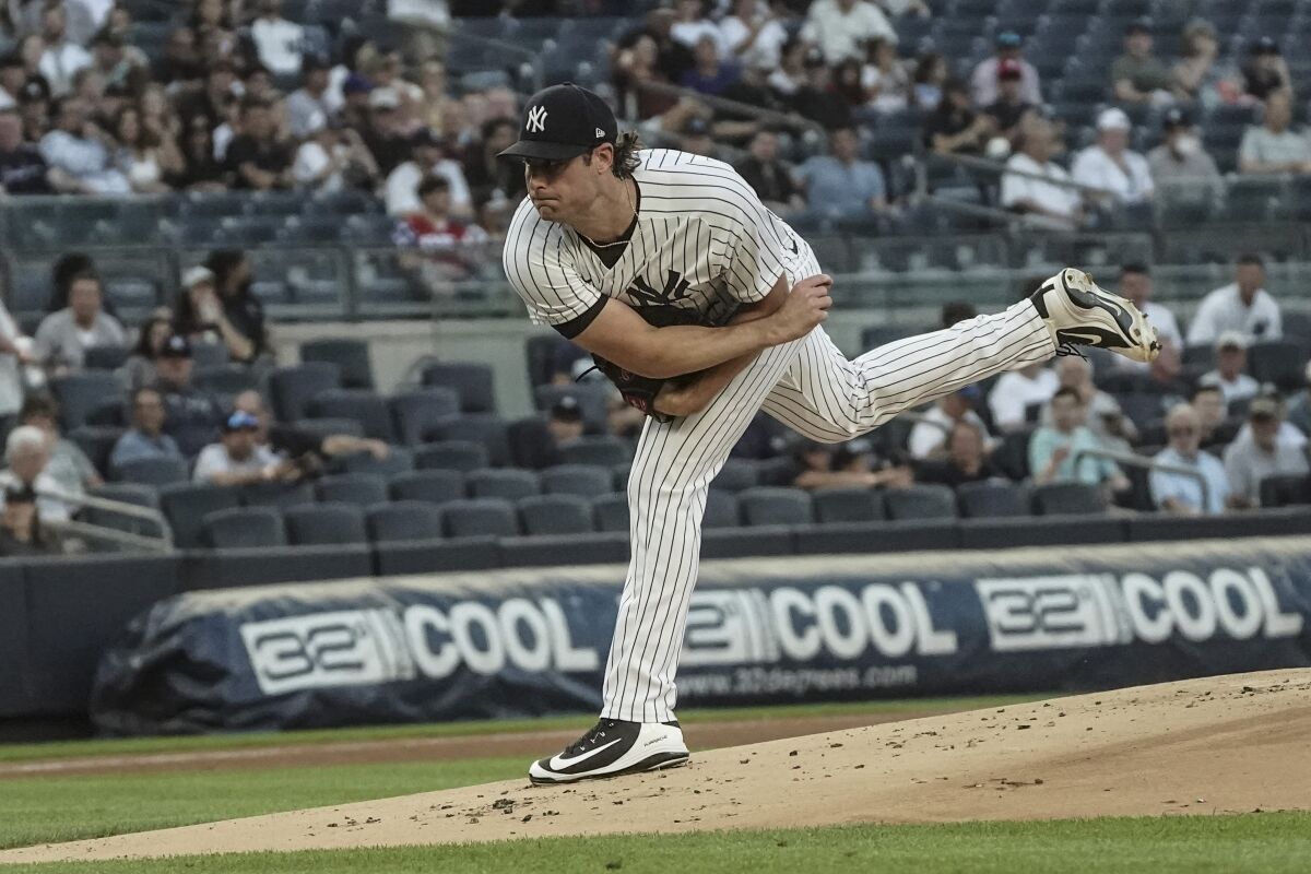New York Yankees pitcher Gerrit Cole (45) throws a strike in the first inning of a baseball game against the Tampa Bay Rays, Tuesday June 14, 2022, in New York. (AP Photo/Bebeto Matthews)