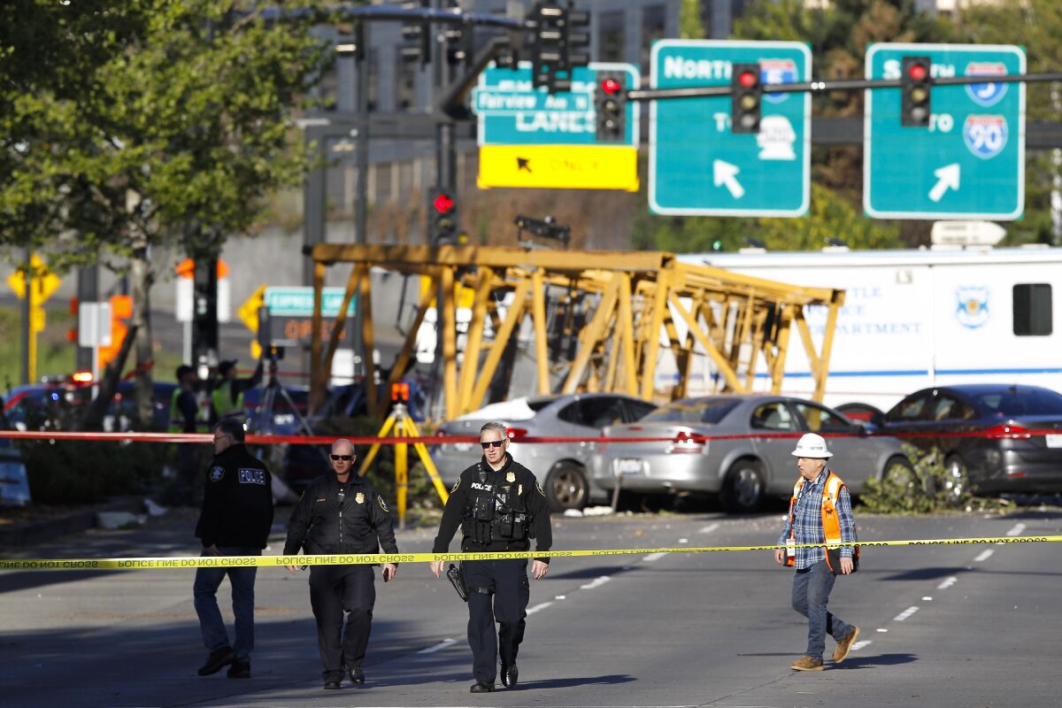FILE- Emergency crews work at the scene of a construction crane collapse that killed four people on April 27, 2019, in the South Lake Union neighborhood of Seattle. A jury on Monday, March 14, 2022, awarded more than $150 million to some of the victims of the high-profile accident. (AP Photo/Joe Nicholson, File)