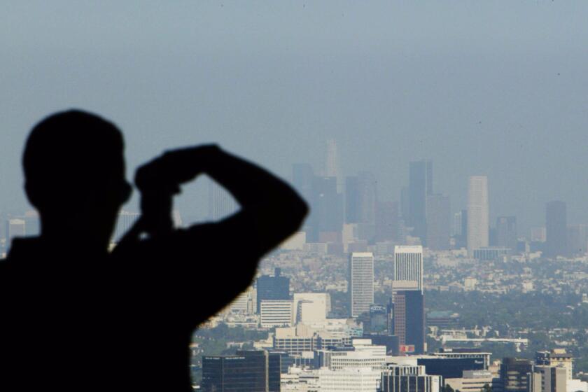 A nationwide study finds that Southern California has the most to gain from stricter air quality standards, which could prevent thousands of premature deaths each year. Above, a hazy view of downtown Los Angeles.