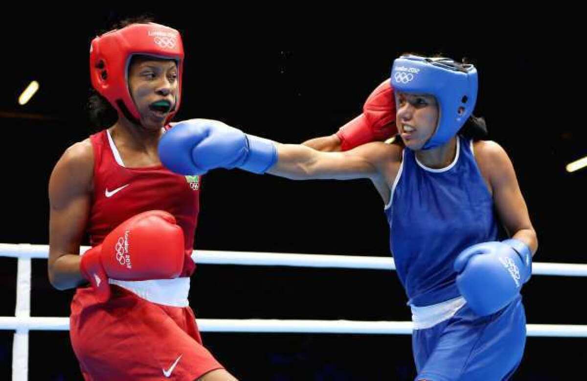 Karlha Magiliocco of Venezuela, right, in action with Erica Matos of Brazil during the debut of women's boxing at the Olympics on Sunday.