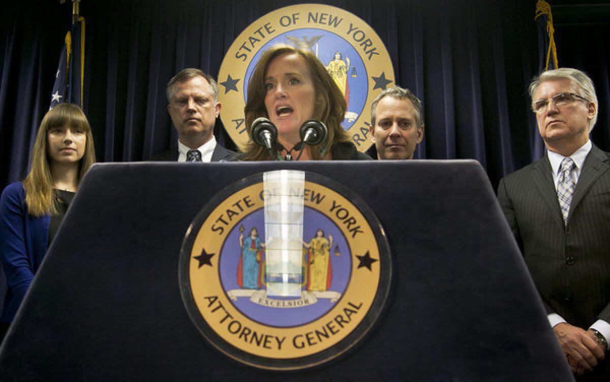 Annie Palazzolo, left, her father Paul Boken, New York Atty. Gen. Eric Schneiderman and San Francisco Dist. Atty. George Gascon listen as Nassau County, N.Y., Dist. Atty. Kathleen Rice speaks during a news conference in New York. The group announced the launch of the Secure Our Smartphones Initiative to encourage the cellphone industry to adapt technology to deter cellphone theft. Palazzolo, 29, spoke about her sister, who was killed for her iPhone.