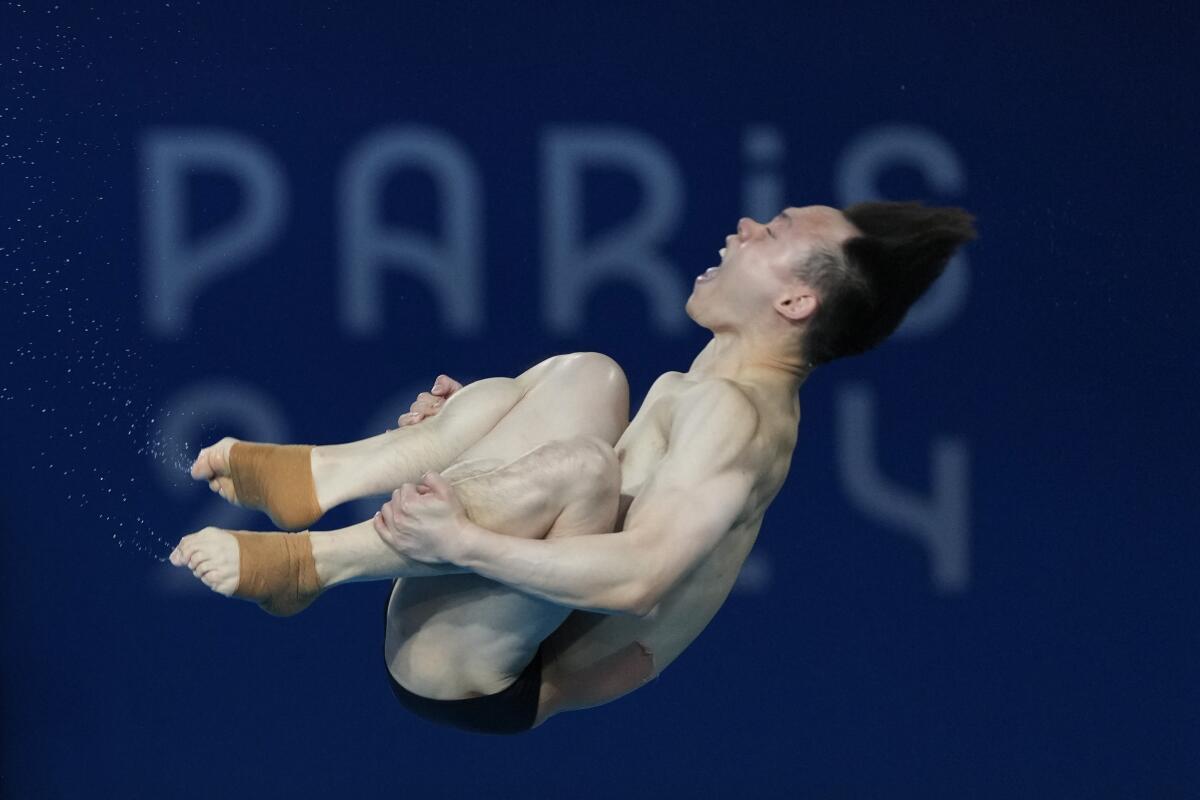 China's Xie Siyi competes in the men's three-meter springboard final Thursday en route to winning gold.