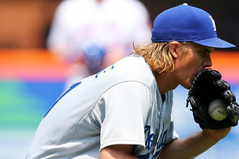 Dodgers pitcher Zack Greinke reacts after his scoreless inning streak ends against the Mets.