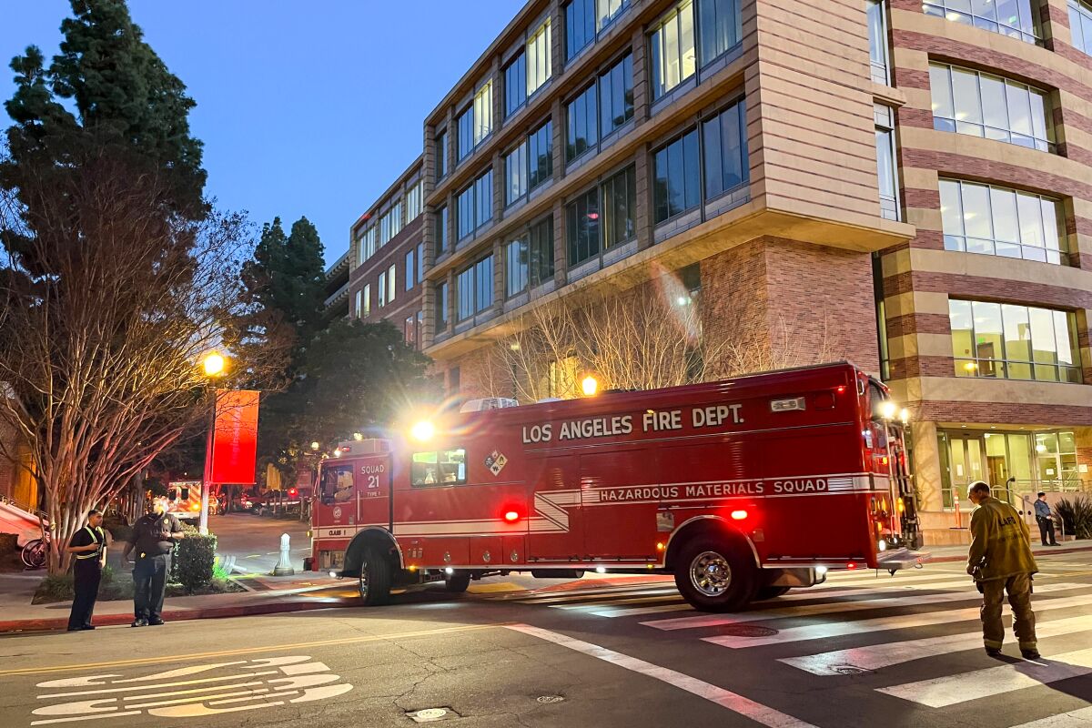 A Los Angeles fire truck in a crosswalk outside a university building