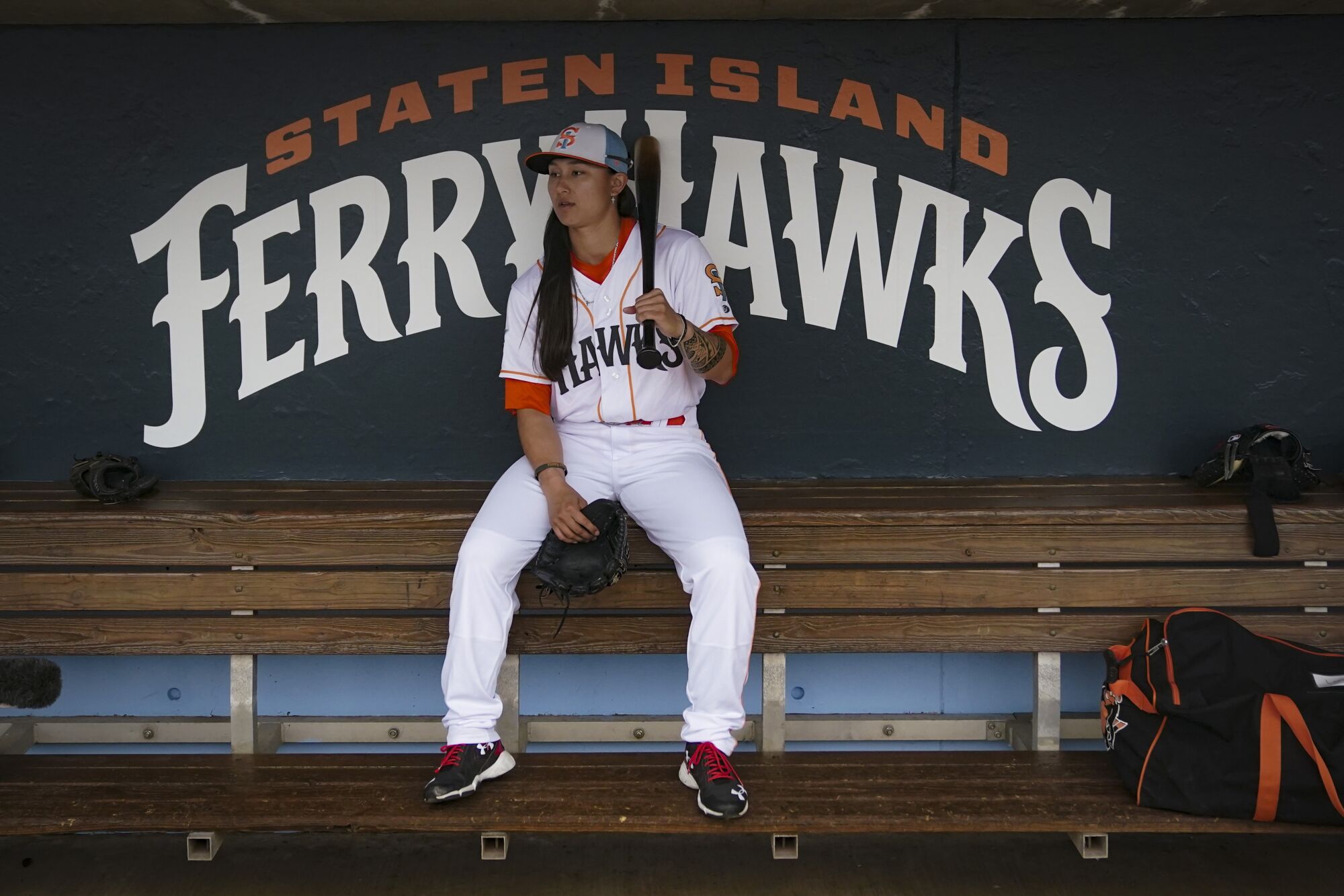 Kelsie Whitmore, a two-way player for the Atlantic League's Staten Island FerryHawks, sits in her team's dugout