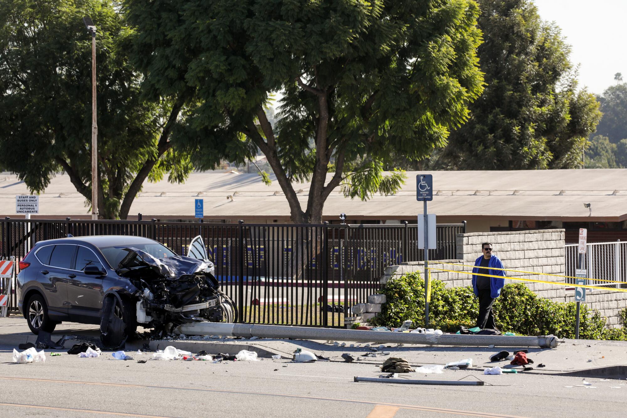 A resident surveys the crash scene, where Los Angeles County sheriff's cadets were injured 