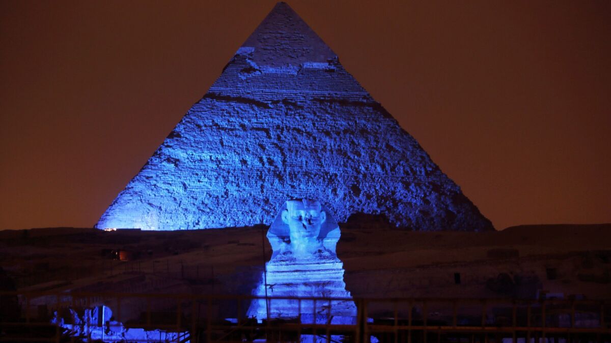 The Sphinx and the historical site of the Giza Pyramids are illuminated as part of the celebration of the 70th anniversary of the United Nations in Giza, just outside Cairo on Oct. 24, 2015.