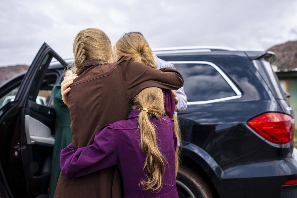 Three girls embracing