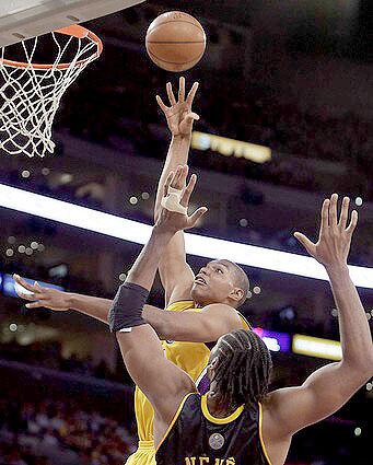Lakers center Andrew Bynum elevates for a shot over Denver's Nene during the third quarter Thursday night.