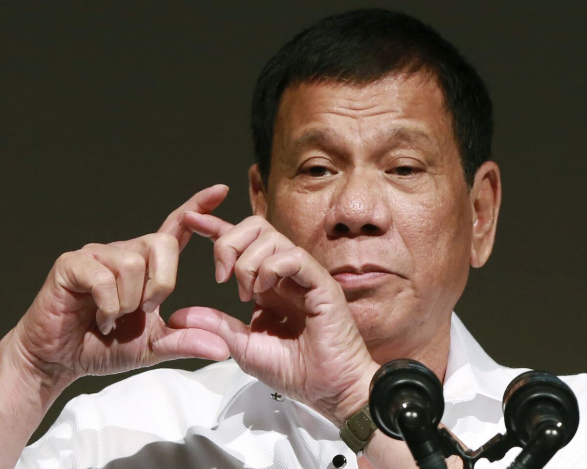 Philippine President Rodrigo Duterte makes a sign with his hands