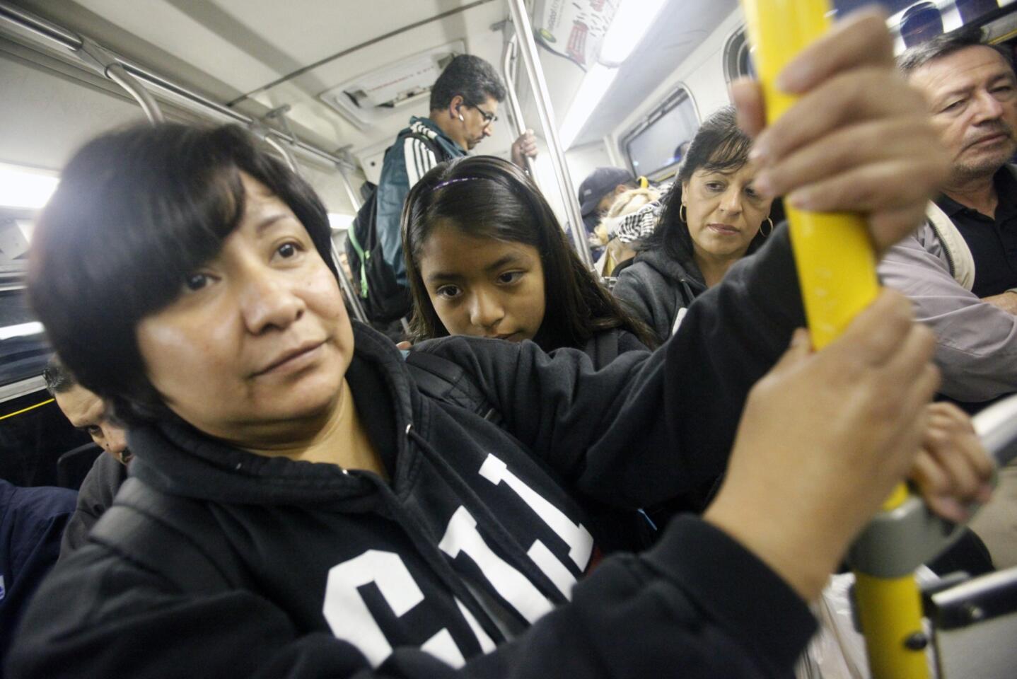 Carmen Mendoza and her daughter Nicole, 11, ride the 760 bus at the beginning of their 15-mile trek by MTA bus from their home in Bell Gardens to school and work in downtown L.A.