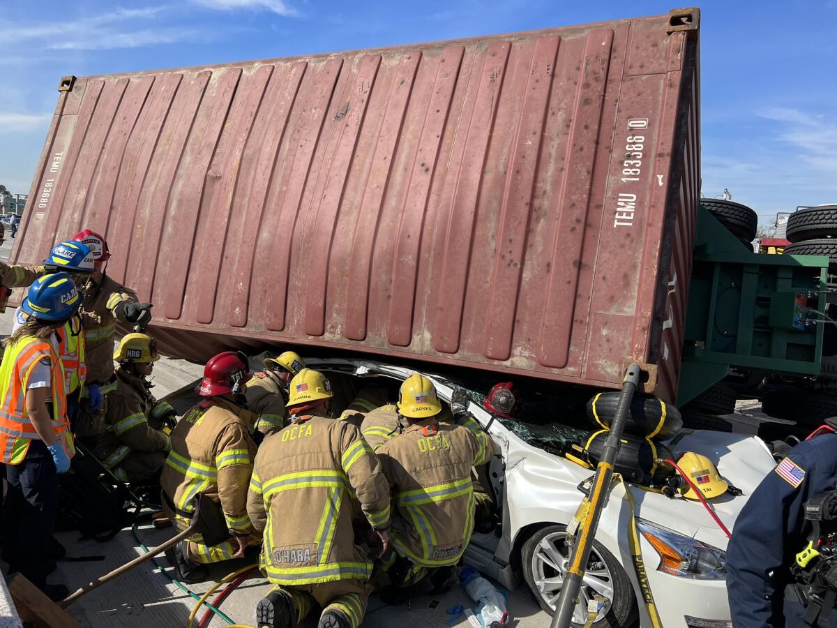 A tractor-trailer overturned onto a vehicle on the southbound 405 Freeway at Seal Beach Boulevard Friday afternoon. 
