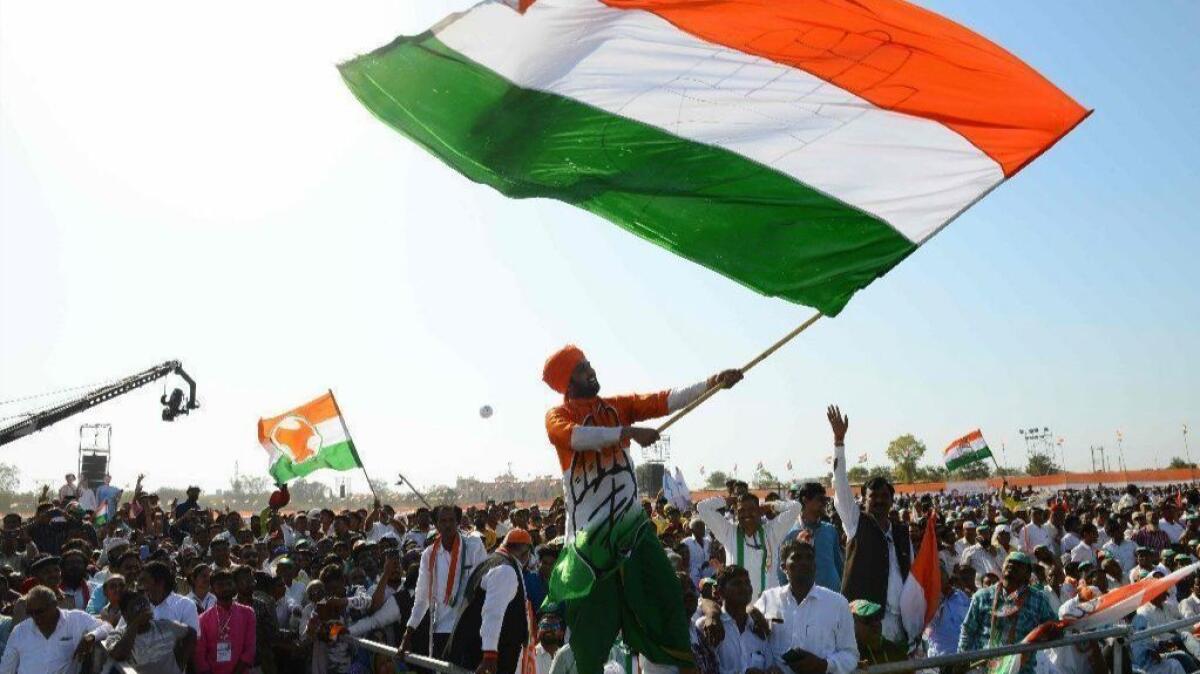 Supporters of India's opposition Congress party cheer at an election rally outside the city of Ahmedabad on March 12.