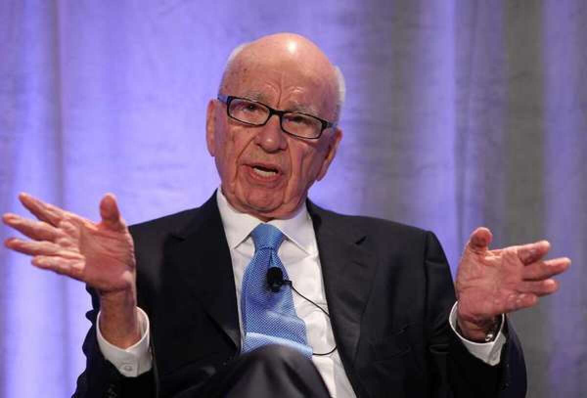 News Corp. disclosed that it would take as much as a $1.4-billion write-down in publishing during the current fiscal quarter. Rupert Murdoch, chief executive of the corporation, is pictured here in 2011.