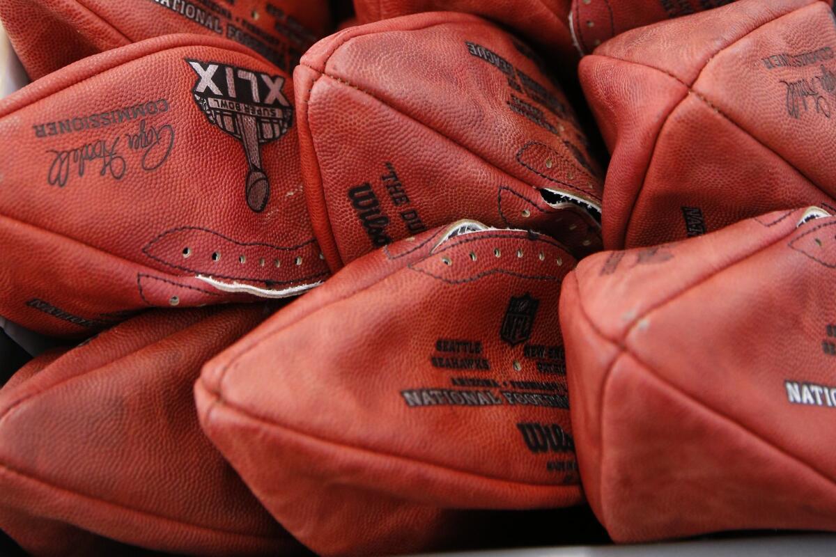 Official game balls for the Super Bowl sit in a bin at the Wilson Sporting Goods Co. in Ada, Ohio, on Jan. 20 before being laced and inflated.