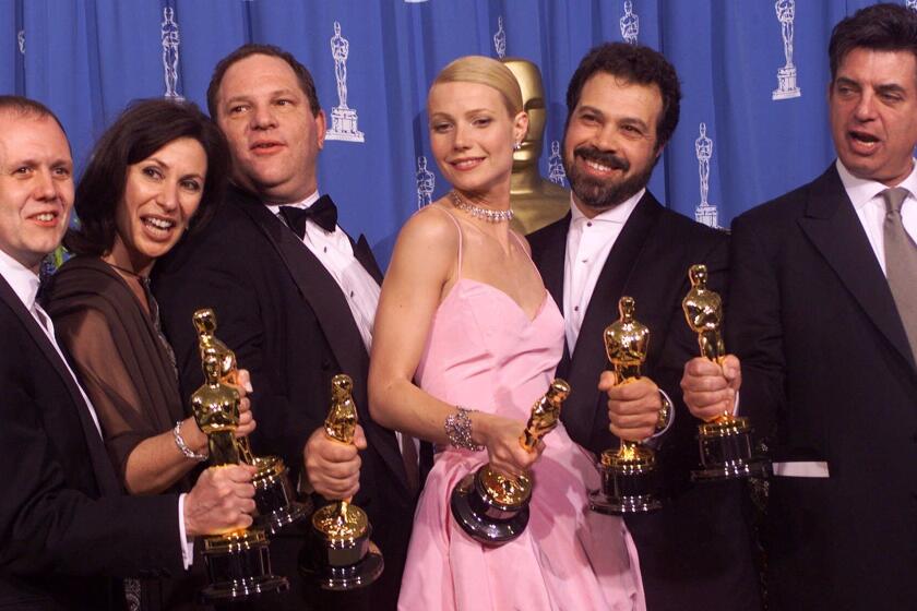 From left to right, David Parfitt, Donna Gigliotti, Harvey Weinstein, Gwyneth Paltrow, Edward Zwick and Marc Norman all celebrate after receiving the Oscar for best picture for "Shakespeare In Love" during the 71st Annual Academy Awards Sunday, March 21, 1999, at the Dorothy Chandler Pavilionof the Los Angeles Music Center. Paltrow won the Oscar for best actress in the movie. (AP Photo/Dave Caulkin)