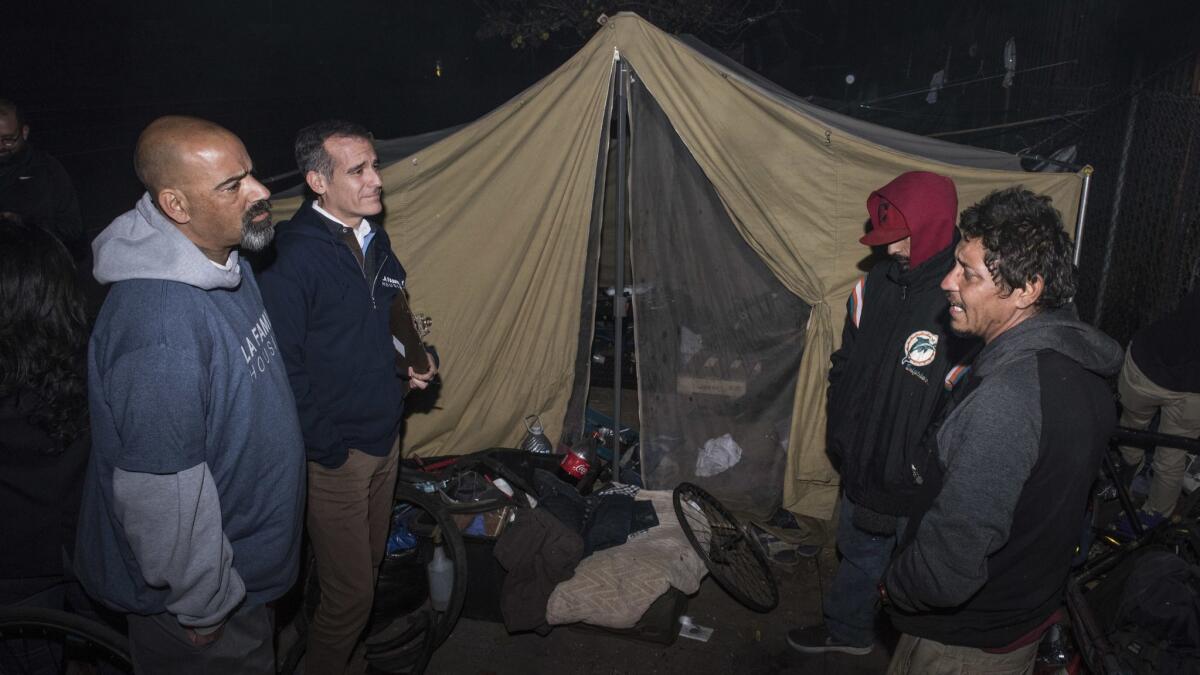 Los Angeles Mayor Eric Garcetti, second from left, talks with Manny Munoz and Ricardo Seleuco in North Hollywood in January during an annual count of the city's homeless population.