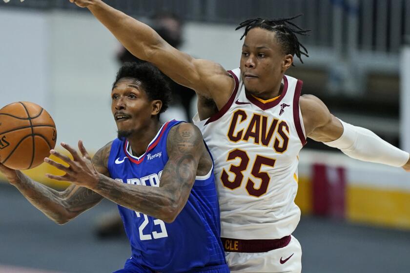 Los Angeles Clippers' Lou Williams (23) drives to the basket against Cleveland Cavaliers' Isaac Okoro (35) in the second half of an NBA basketball game, Wednesday, Feb. 3, 2021, in Cleveland. The Clippers won 121-99. (AP Photo/Tony Dejak
