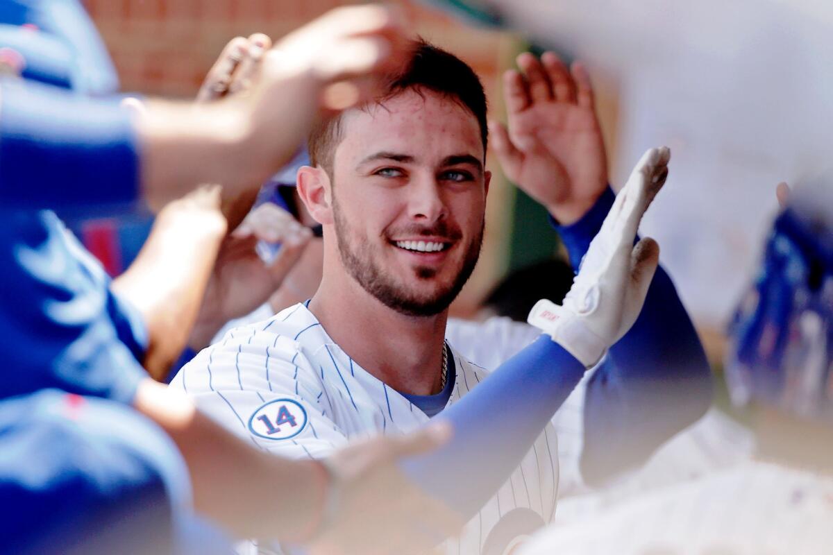 Cubs third baseman Kris Bryant is congratuated in the dugout after hitting a two-run home run against the Braves on Aug. 23.