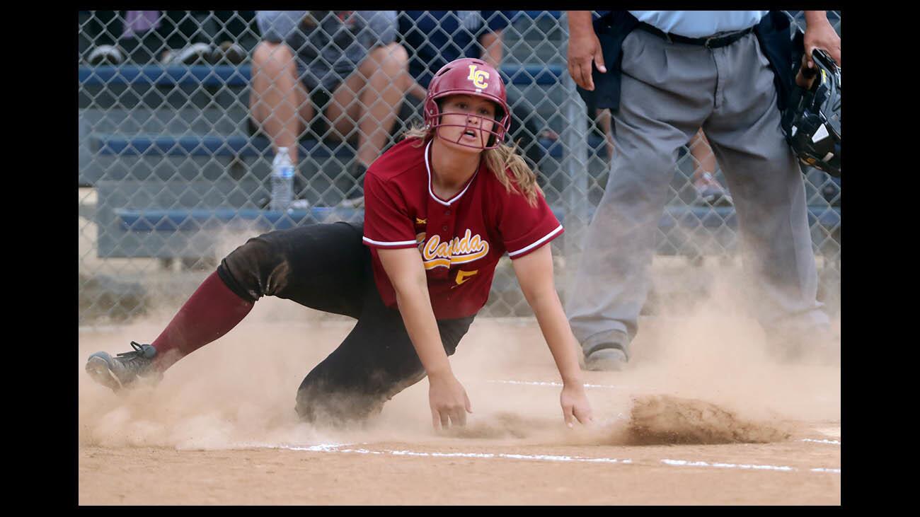 La Canada High School softball shortstop Emily Tinkham, #5, slides into home plate in the first inning to notch the only run the Spartans would score in CIF SS Div. V quarterfinal game at Chaminade, in Chatsworth on Thursday, May 24, 2018.