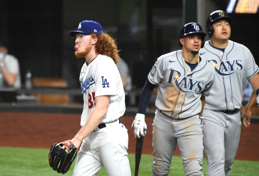 Dodgers pitcher Dustin May walks back to the mound after giving up a two-run double to the Tampa Bay Rays.
