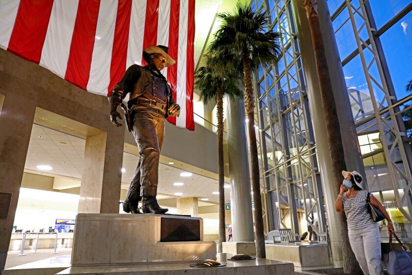 A statue of John Wayne at his namesake airport in Orange County.