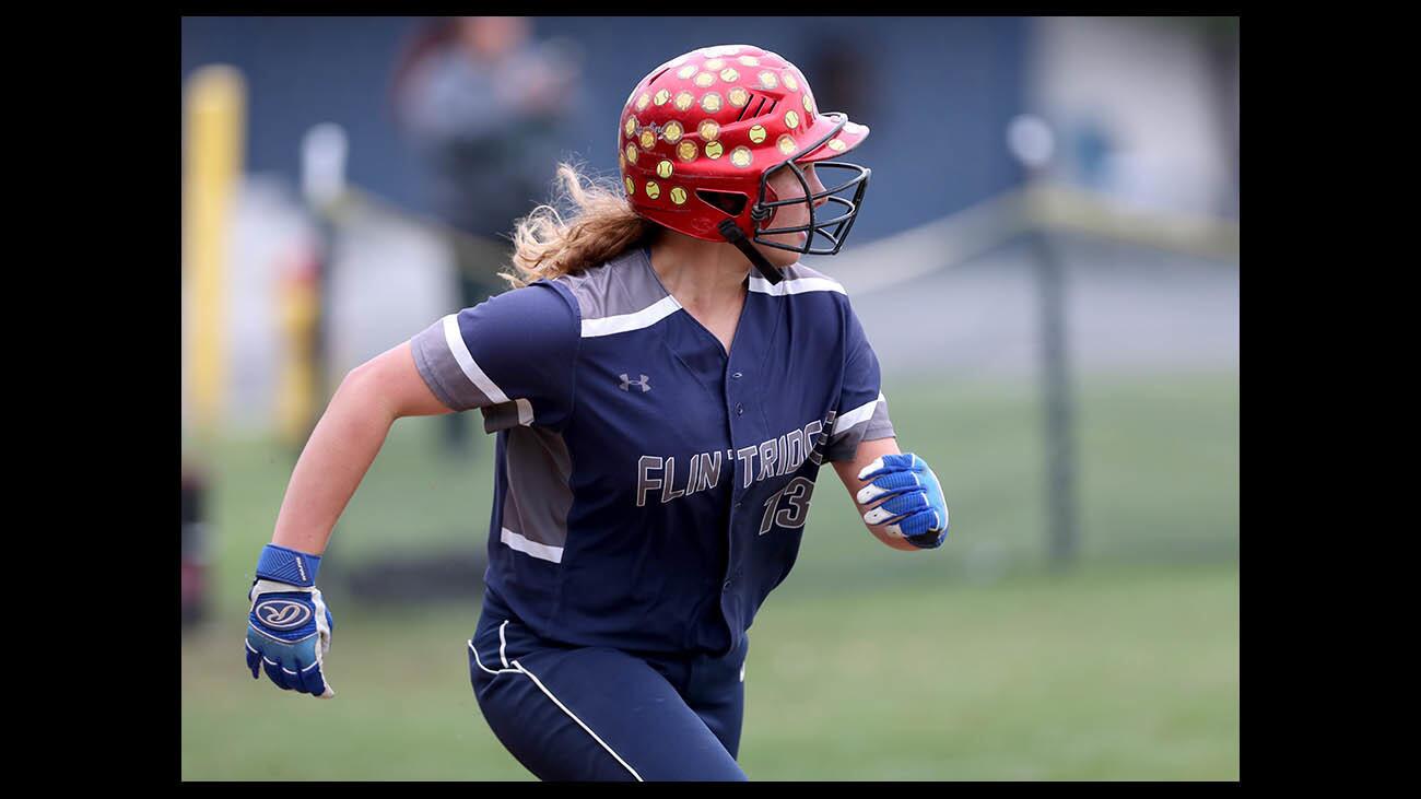 Flintridge Prep softball player #13 Emma Stellar watches the ball go over the fence for a home run as she dashes to first base in the bottom of the fourth inning in second round game of the CIF SS Div. VII softball playoffs, at home vs. San Gabriel Mission, in LA Canada Flintridge on Tuesday, May 22, 2018.