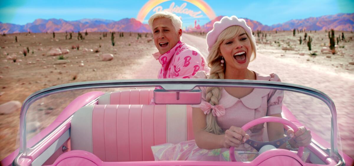 Margot Robbie drives a pink convertible as Ryan Gosling sits in the backseat.