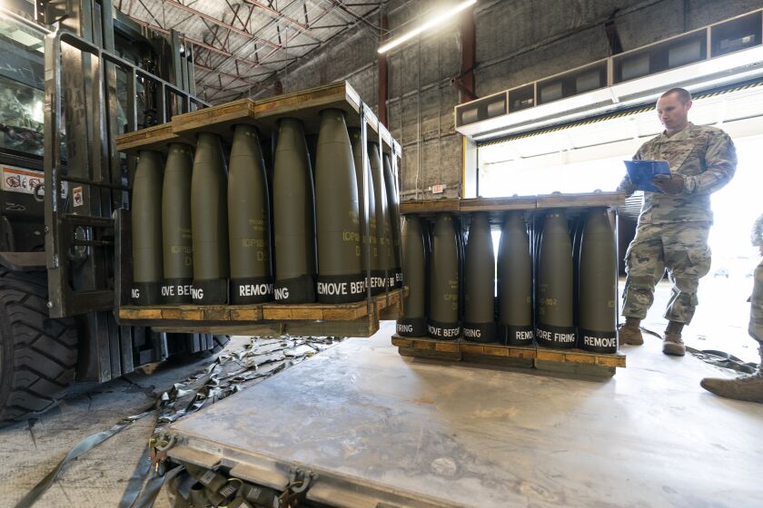 FILE - U.S. Air Force Staff Sgt. Cody Brown, right, with the 436th Aerial Port Squadron, checks pallets of 155 mm shells ultimately bound for Ukraine, April 29, 2022, at Dover Air Force Base, Del. Officials say the U.S. will send $400 million more in military aid to Ukraine amid concerns financial assistance for the war against Russia could decline if Republicans take control of Congress. (AP Photo/Alex Brandon, File)