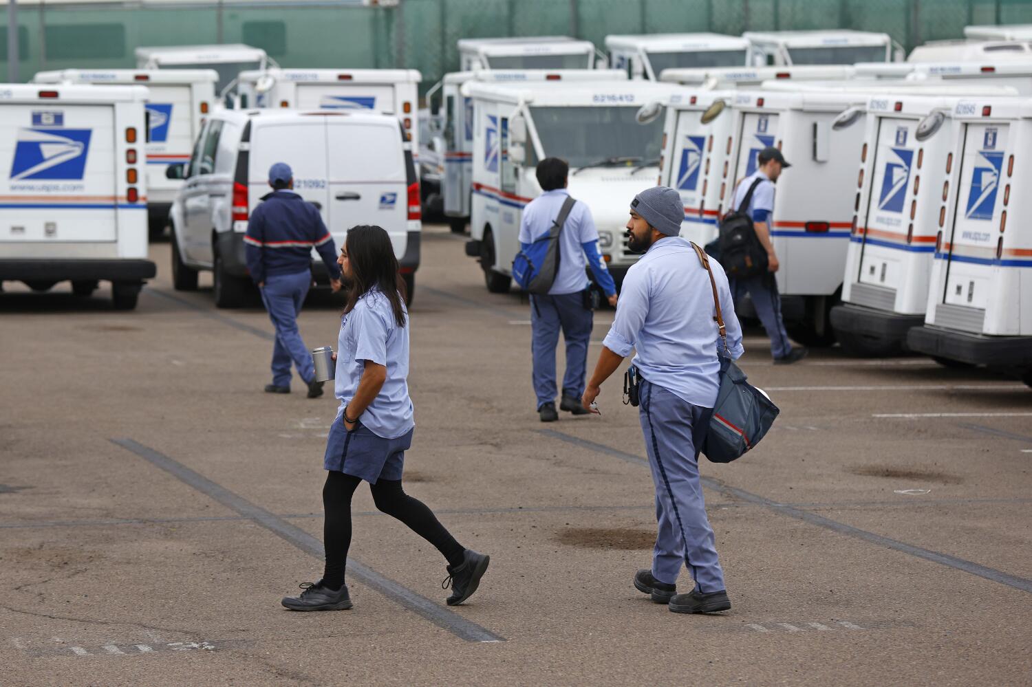 November 2023: Letter carriers go out for morning vehicle inspections on their route at the main post office in Chula Vista.