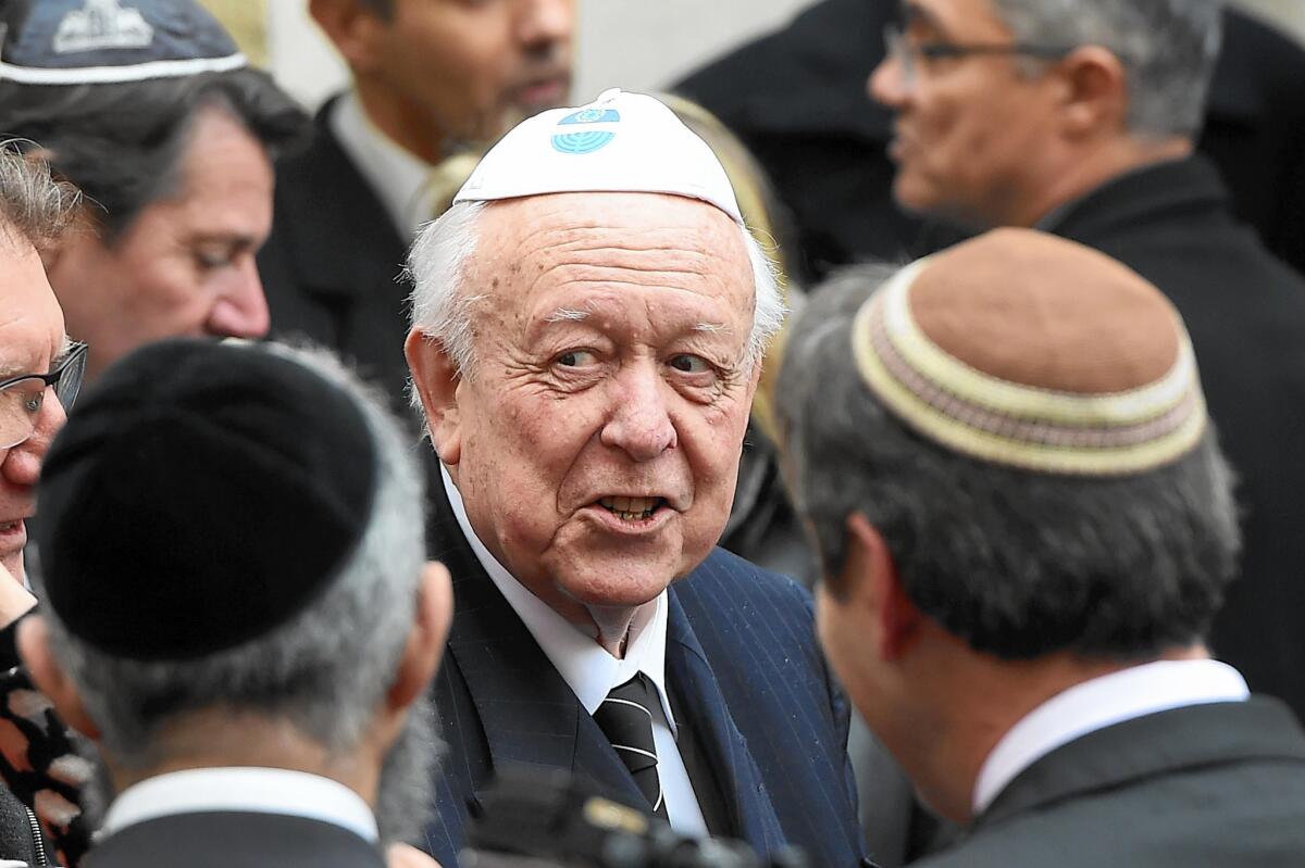 Jean-Claude Gaudin, mayor of Marseille, speaks with members of the Jewish community in the city's main synagogue after an attack on a Jewish teacher.