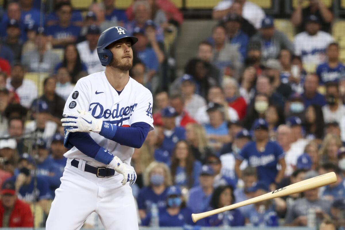 Dodgers' Cody Bellinger tosses his bat after being walked.
