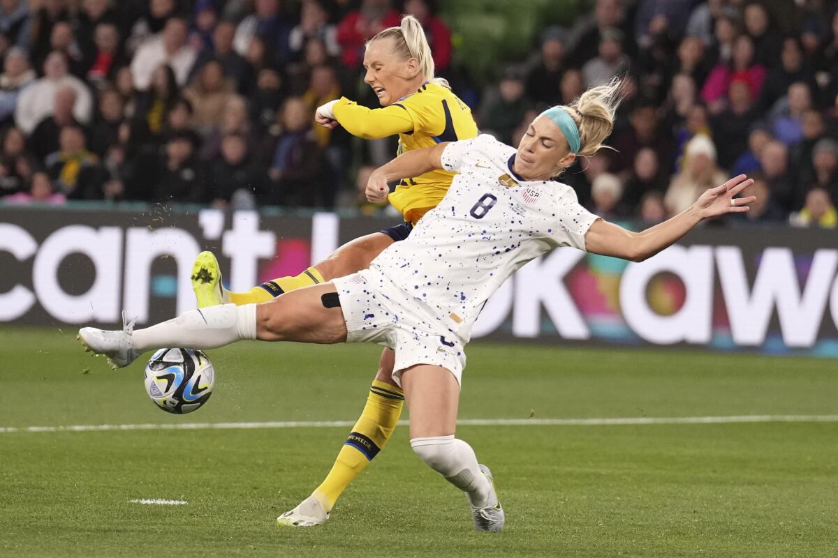 Sweden's Stina Blackstenius, left, and United States' Julie Ertz battle for the ball.