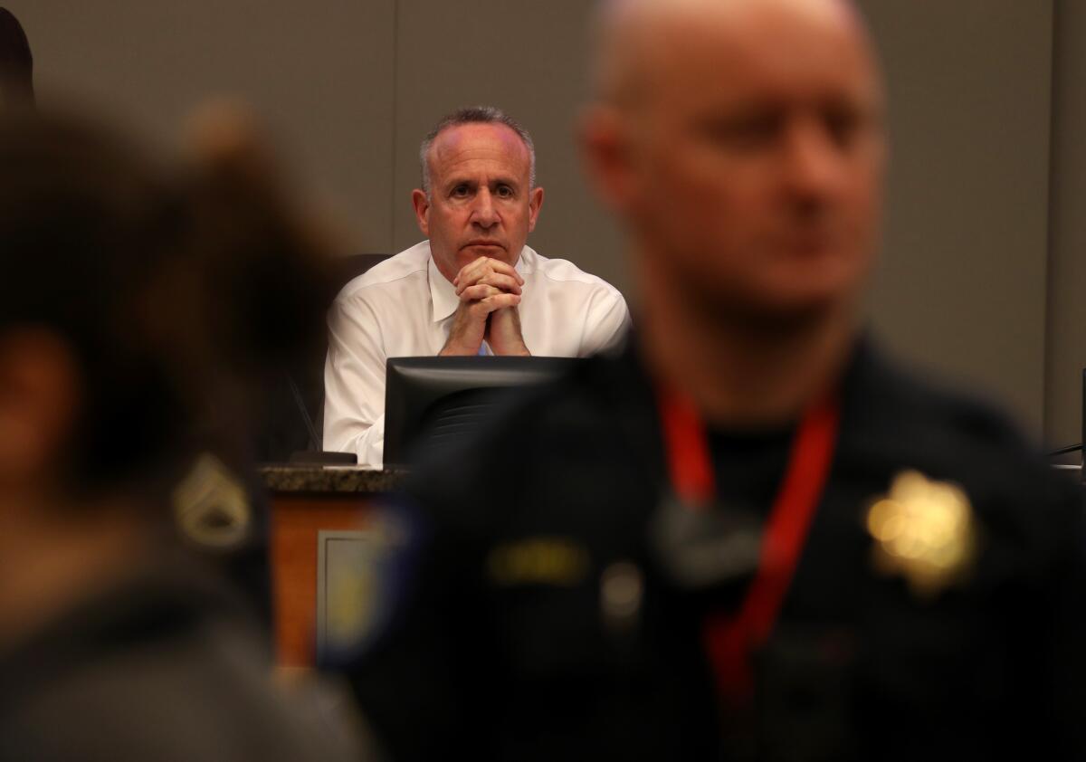 Sacramento Mayor Darrell Steinberg listens with hands folded at a council meeting.