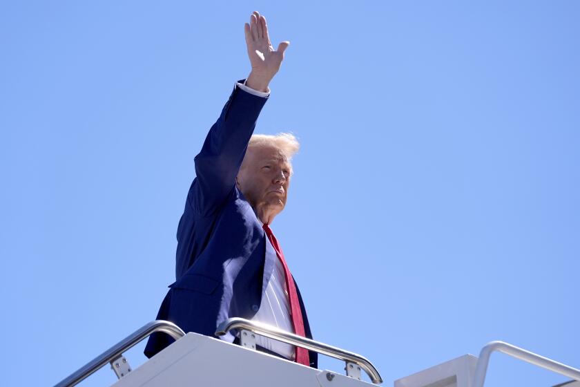 Republican presidential nominee former President Donald Trump waves as he boards a plane at Harry Reid International Airport after a campaign trip, Saturday, Sept.14, 2024, in Las Vegas. (AP Photo/Alex Brandon)