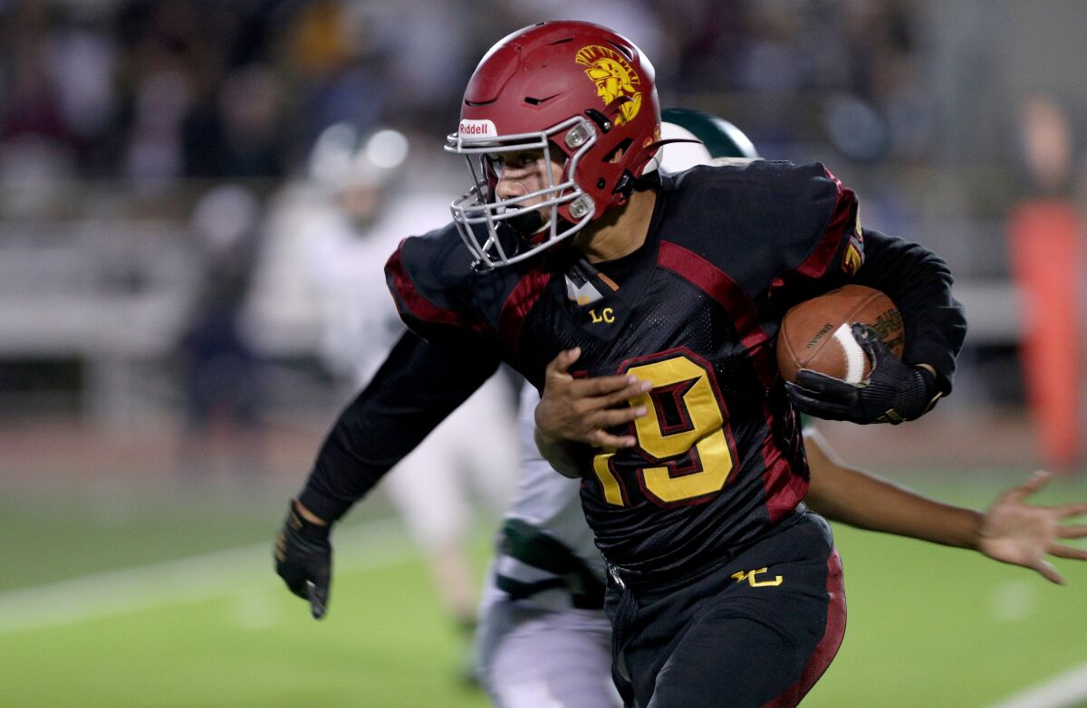 La Canada High's Justin Zoltzman caught a pass for a 22-yard gain in the first quarter of the Spartans' game against Monrovia on Friday.