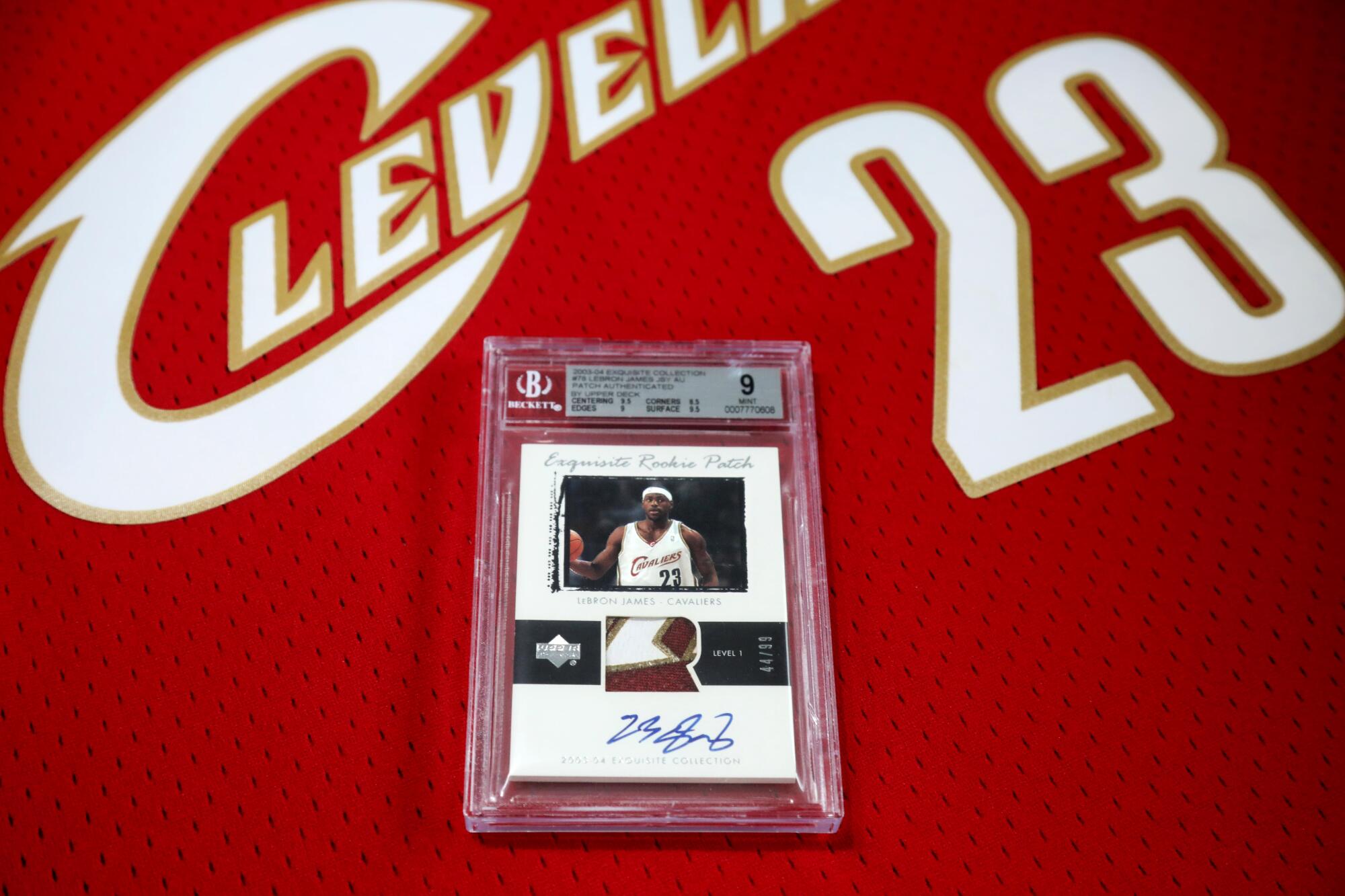 A LeBron James rookie card rests on a Cleveland Cavaliers jersey