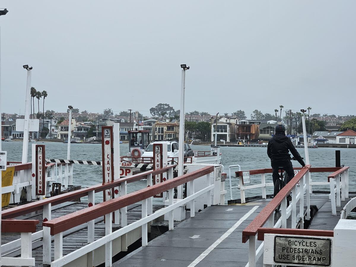 The Balboa Ferry carries in a car from Balboa Island on Sunday.